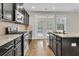 Kitchen with granite countertops, stainless appliances, and access to outdoor deck at 295 Calm Water Way, Summerville, SC 29486