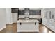 Kitchen island with granite countertop, stainless sink, and dark cabinetry at 295 Calm Water Way, Summerville, SC 29486