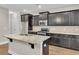 Kitchen boasts granite counters, island, and stainless steel appliances at 295 Calm Water Way, Summerville, SC 29486