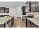 Kitchen with granite countertops, island, stainless steel appliances, and hardwood floors at 295 Calm Water Way, Summerville, SC 29486