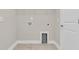 Bright laundry room with white walls and tile flooring is ready for appliances and organizing at 295 Calm Water Way, Summerville, SC 29486