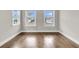 Bright, neutral room features gleaming hardwood floors and double-hung windows at 295 Calm Water Way, Summerville, SC 29486