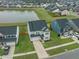 Aerial view of a two-story home with a pond in the backyard, with a well-manicured lawn at 296 Firewheel Ct, Summerville, SC 29486