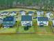 Aerial view of homes with green lawns and fenced backyards in a suburban neighborhood at 296 Firewheel Ct, Summerville, SC 29486