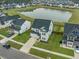 An aerial view of a gray home with green lawns, a sidewalk, and a nearby pond at 296 Firewheel Ct, Summerville, SC 29486