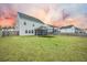 Spacious backyard with green grass, a screened porch, fence, and a trampoline at 296 Firewheel Ct, Summerville, SC 29486