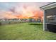 Grassy backyard with a trampoline near the screened-in porch overlooking the fenced yard at 296 Firewheel Ct, Summerville, SC 29486