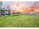 Well-maintained backyard featuring green grass, a fence, and a trampoline at 296 Firewheel Ct, Summerville, SC 29486