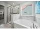 Modern bathroom featuring separate shower and soaking tub with natural light at 296 Firewheel Ct, Summerville, SC 29486