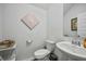Half bathroom with a pedestal sink, toilet, and decorative artwork at 296 Firewheel Ct, Summerville, SC 29486