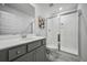 Bright bathroom featuring gray vanity, toilet, and walk-in shower with sliding glass doors at 296 Firewheel Ct, Summerville, SC 29486