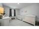 Bright Bedroom featuring two cribs, neutral walls, and stylish decor at 296 Firewheel Ct, Summerville, SC 29486