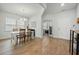 Bright dining area with hardwood floors, a white table, and a view into the office at 296 Firewheel Ct, Summerville, SC 29486