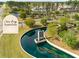 Community entrance with water feature and landscaping; community name 