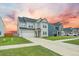 Beautiful two-story home with well-manicured lawn on a partly cloudy day at 296 Firewheel Ct, Summerville, SC 29486