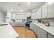 Bright kitchen featuring white countertops, custom gray cabinets, backsplash, and stainless steel appliances at 296 Firewheel Ct, Summerville, SC 29486