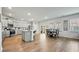 Open-concept kitchen featuring grey cabinetry, stainless steel appliances, island with seating, and breakfast table at 296 Firewheel Ct, Summerville, SC 29486