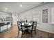 Open kitchen and breakfast nook with grey cabinets, island seating, stainless appliances and lots of natural light at 296 Firewheel Ct, Summerville, SC 29486