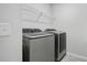 Modern laundry room with new washer and dryer, and wire shelving at 296 Firewheel Ct, Summerville, SC 29486