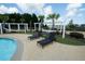 Relaxing pool deck with lounge chairs, pergolas, hammocks, and lush landscaping at 296 Firewheel Ct, Summerville, SC 29486