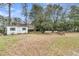 Large, green backyard with a storage shed, picnic tables, and plenty of space for outdoor activities at 301 E Richardson Ave, Summerville, SC 29483