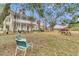 Expansive backyard featuring outdoor seating, mature trees, and a classic picnic table at 301 E Richardson Ave, Summerville, SC 29483
