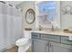 Well-lit bathroom featuring a vanity, a toilet, and a shower with modern fixtures at 301 E Richardson Ave, Summerville, SC 29483