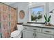 Bathroom featuring a window, cabinet and colorful shower curtain at 301 E Richardson Ave, Summerville, SC 29483