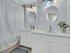 Bathroom with dual sinks, white cabinets, and good lighting, creating a fresh and clean space at 301 E Richardson Ave, Summerville, SC 29483