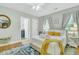 Bright bedroom featuring a comfortable bed, stylish decor, and an ensuite bathroom at 301 E Richardson Ave, Summerville, SC 29483