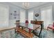 Spacious dining room with chandelier, traditional furniture, and light-filled windows at 301 E Richardson Ave, Summerville, SC 29483