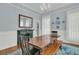 Formal dining room with traditional fireplace, chandelier lighting, and colorful rug at 301 E Richardson Ave, Summerville, SC 29483