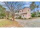 Charming home with an exterior staircase, manicured landscaping, and a well-maintained driveway at 301 E Richardson Ave, Summerville, SC 29483