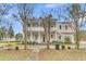 Two-story home featuring columns, double porches and side stairs at 301 E Richardson Ave, Summerville, SC 29483