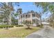 Two-story home featuring columns, double porches and manicured landscaping at 301 E Richardson Ave, Summerville, SC 29483