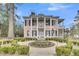 Charming two-story home with columns, fountain and landscaped front yard at 301 E Richardson Ave, Summerville, SC 29483