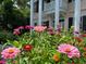 Two-story home featuring white columns and colorful flower gardens adding curb appeal at 301 E Richardson Ave, Summerville, SC 29483