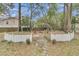 Beautiful backyard fire pit area featuring a white picket fence, metal arch, and stone pathway at 301 E Richardson Ave, Summerville, SC 29483