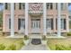 Close-up of a front porch featuring columns and white rocking chairs at 301 E Richardson Ave, Summerville, SC 29483