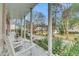 Charming front porch with white columns, chairs, and landscaped garden. Great curb appeal at 301 E Richardson Ave, Summerville, SC 29483