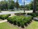 Landscaped front yard features lush greenery, flowerbeds, and a decorative fountain, enhancing the property's curb appeal at 301 E Richardson Ave, Summerville, SC 29483