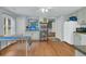 Bright kitchen with white appliances and ample storage space, accentuated by the natural hardwood floors at 301 E Richardson Ave, Summerville, SC 29483