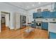 Well-equipped kitchen with stainless appliances, blue cabinets, and ample counter space at 301 E Richardson Ave, Summerville, SC 29483