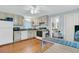 Charming kitchen featuring white cabinets and appliances, complemented by warm hardwood floors at 301 E Richardson Ave, Summerville, SC 29483
