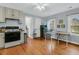 Cozy kitchen with wooden floors, stainless steel appliances, and bright, natural light at 301 E Richardson Ave, Summerville, SC 29483