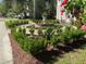 Detailed landscaping featuring a decorative statue and lush plants at 301 E Richardson Ave, Summerville, SC 29483