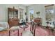 Bright living room featuring hardwood floors, large windows, and antique furniture at 301 E Richardson Ave, Summerville, SC 29483