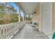 Inviting porch showcasing white railings and ample seating area with natural light and view at 301 E Richardson Ave, Summerville, SC 29483