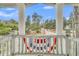 Charming porch view showcasing a picturesque street and lush greenery at 301 E Richardson Ave, Summerville, SC 29483