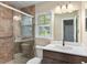 Bathroom featuring tiled shower with glass door, vanity with modern sink, and bright window at 303 Hamlet Rd, Summerville, SC 29485